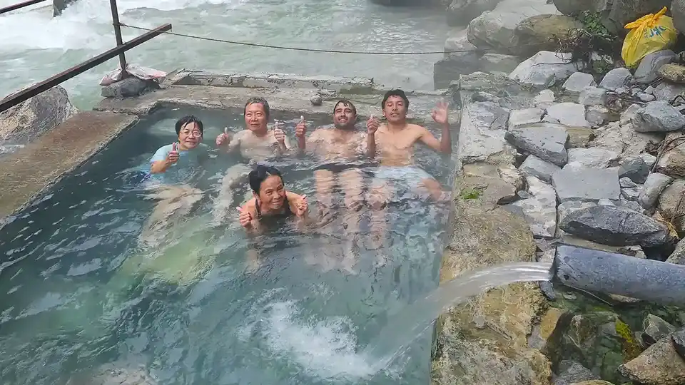 Several people enjoying bath on one of the hotsprings of Annapurna